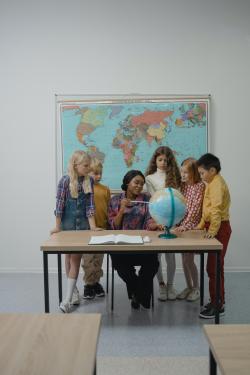 老师带着孩子一起看地球仪